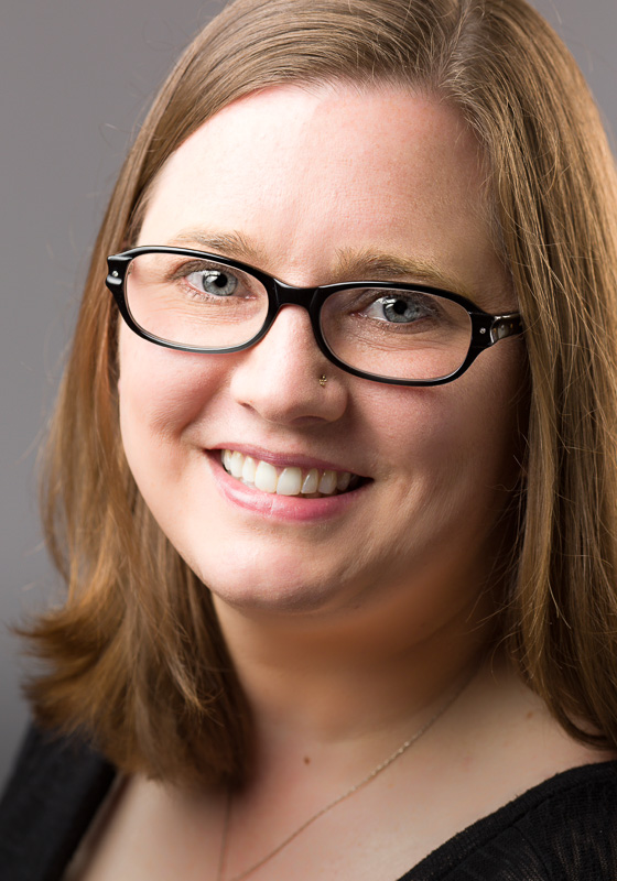 Janna Willoughby wearing glasses and smiling at the camera